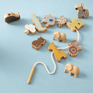 Houten rijgspeelgoed met blauwe dinosaurus